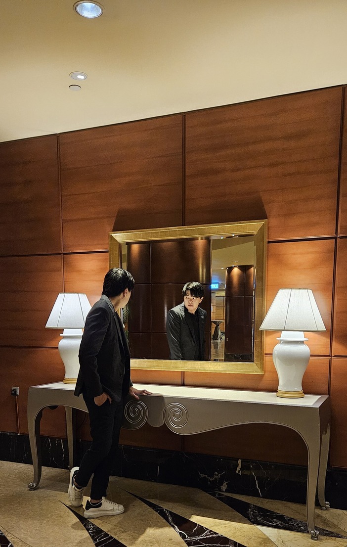 Fullerton Hotel's decorative mirror, reflecting the luxury of the lobby