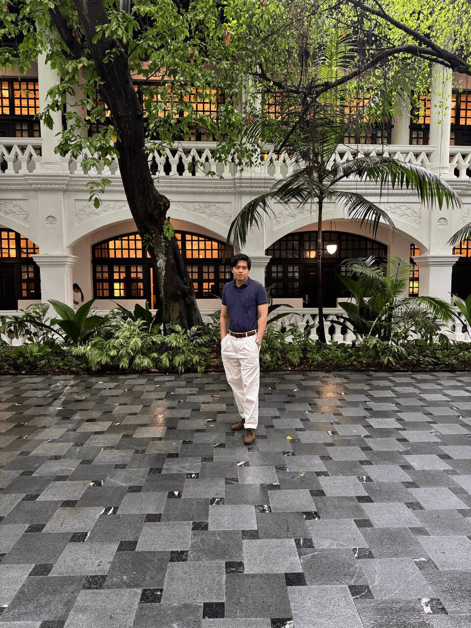 Raffles Hotel courtyard with lush greenery and heritage charm